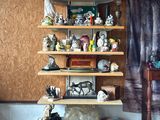 a shelf that has a lot of figurines on it