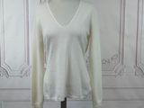 a picture of a white sweater on a mannequin stand