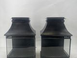 a pair of black metal lanterns on a white background