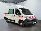 the white van is parked inside of a building with a red stripe on the side of the van