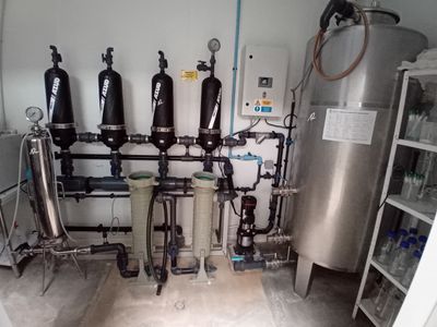 a room with a bunch of pipes and a water heater