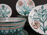 many plates and bowls that are sitting on a table