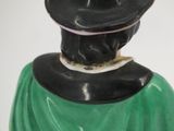a figurine of a man with a hat on his head
