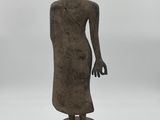 a statue of a person standing on top of a red pedestal