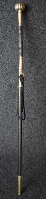 a small metal pole with a metal handle on a black surface