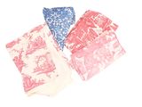 three napkins with different designs on them on a white surface