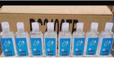 six bouteilles d'eau sont alignées devant une boîte en carton