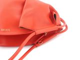 an image of a red purse with a strap on a white background