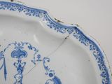 a blue and white plate with a design on it