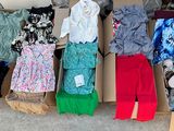 a lot of clothes in a box on the floor
