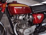 a red motorcycle that is parked in a garage