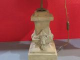 a lamp that is sitting on a table next to a red wall