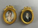 two miniature portraits of a man and a woman in gold frames