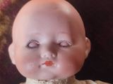 a close up of a doll with eyelashes on it ' s face
