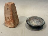 two pieces of pottery sitting next to each other on a table