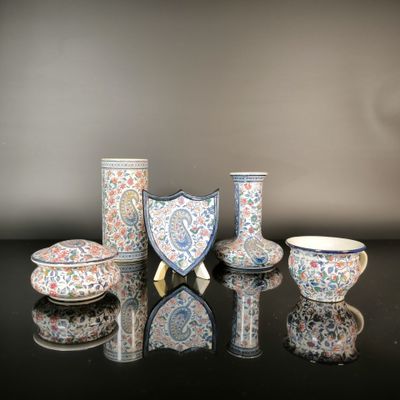 a group of vases and bowls sitting on a table