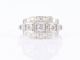 a close up of a diamond and white gold ring on a white surface