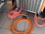 an orange hose on the floor next to an air conditioner