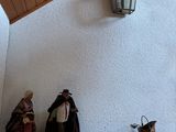 many figurines on a shelf in the corner of a room
