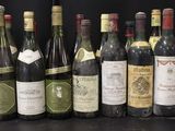 many bottles of wine that are lined up on the table