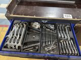 many tools in a tool box on the floor