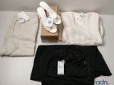 three pairs of shoes and a pair of pants sitting on a table