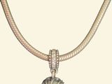 a picture of a necklace with a flower on it