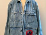 denim jacket with red and blue flower appliqued on the front
