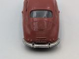 a red toy car that is sitting on a table