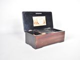 a small wooden box with a picture inside of it