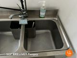 a stainless steel sink with a soap dispenser and a soap dispenser
