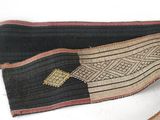 an image of a pair of black and tan belts with a gold arrow on them