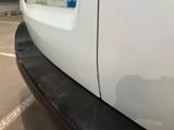 a close up of a white car with a sticker on it