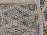 a close up of a rug on a floor with a cat laying on top of it