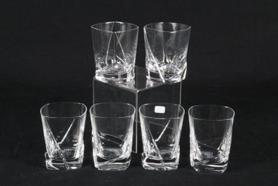 six shot glasses sitting on top of a black table next to each other