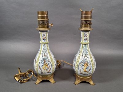 pair of antique porcelain lamps with gold and blue designs on them