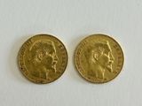 two gold sovereigns, one of which has a head of a man and the other of a woman