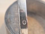 a small metal pan with a spoon in it