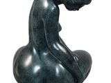 statue of a man sitting on a rock with his head in his hands