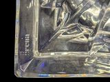 a clear glass tray with a statue inside of it