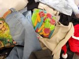 a pile of clothes and toys on a couch