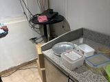 a person taking a picture of a kitchen counter with a cell phone