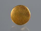a close up of a gold coin on a reflective surface