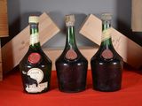three bottles of wine sitting on a table next to each other