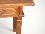 an old wooden table with a drawer on top of it