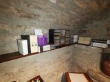 many books on the shelves in the corner of the room