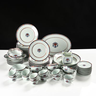a lot of plates and cups sitting on a table