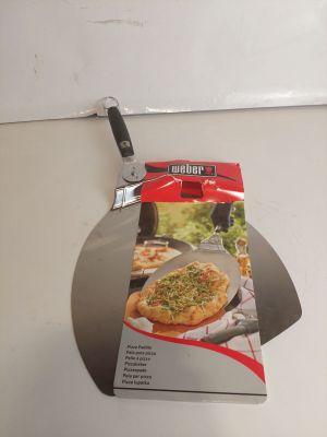 une boîte de pizza posée sur un plan de travail, à côté d'un coupe-pizza