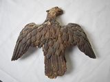 a wooden bird that is sitting on a table