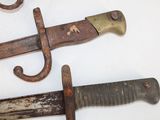 two old knives that are laying on a table